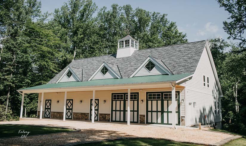 Photograph of the completed barn with cupola and porch