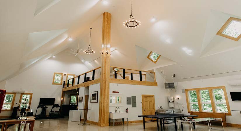 Interior of the barn loft with timber post and vaulted ceiling