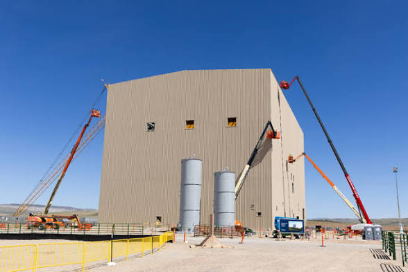 Test and Fill Facility with metal panel enclosure being installed by cranes
